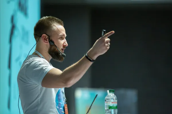 Mikalai pointing at a slide during a talk at Selenium Camp